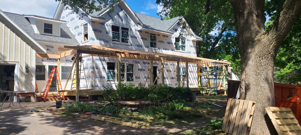 Before — porch framing and NanaWall openings under construction