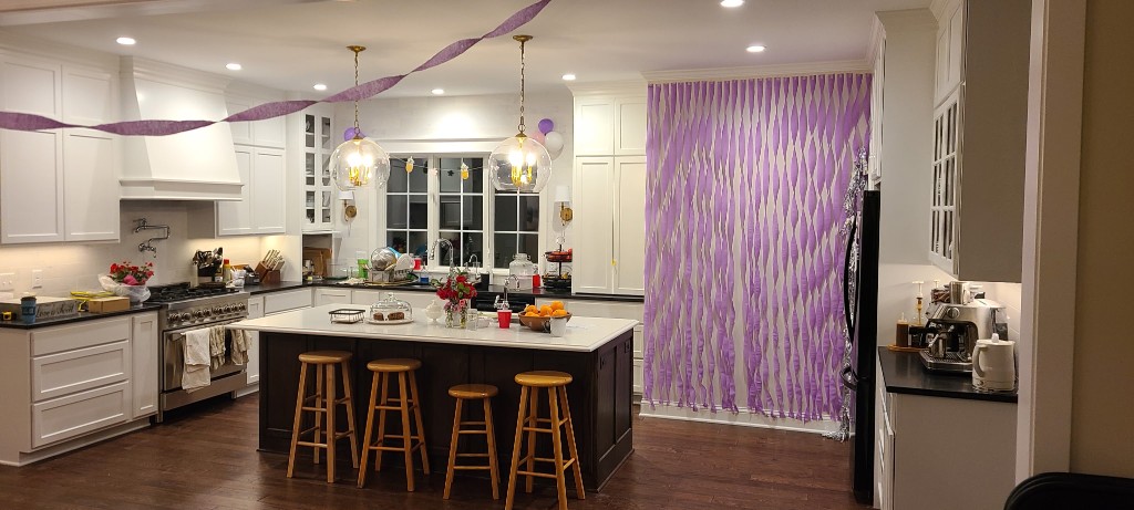 Kitchen with white cabinetry and NanaWall glass panels